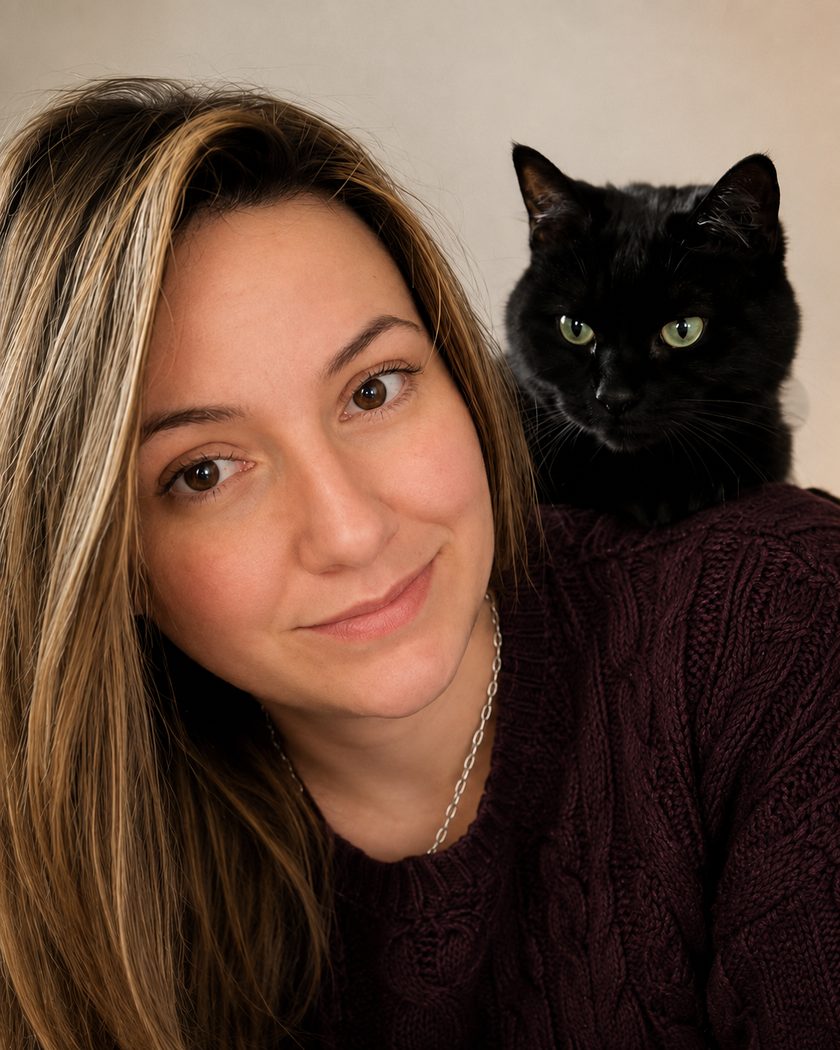 Sally at home with a black cat perched contentedly on her shoulder